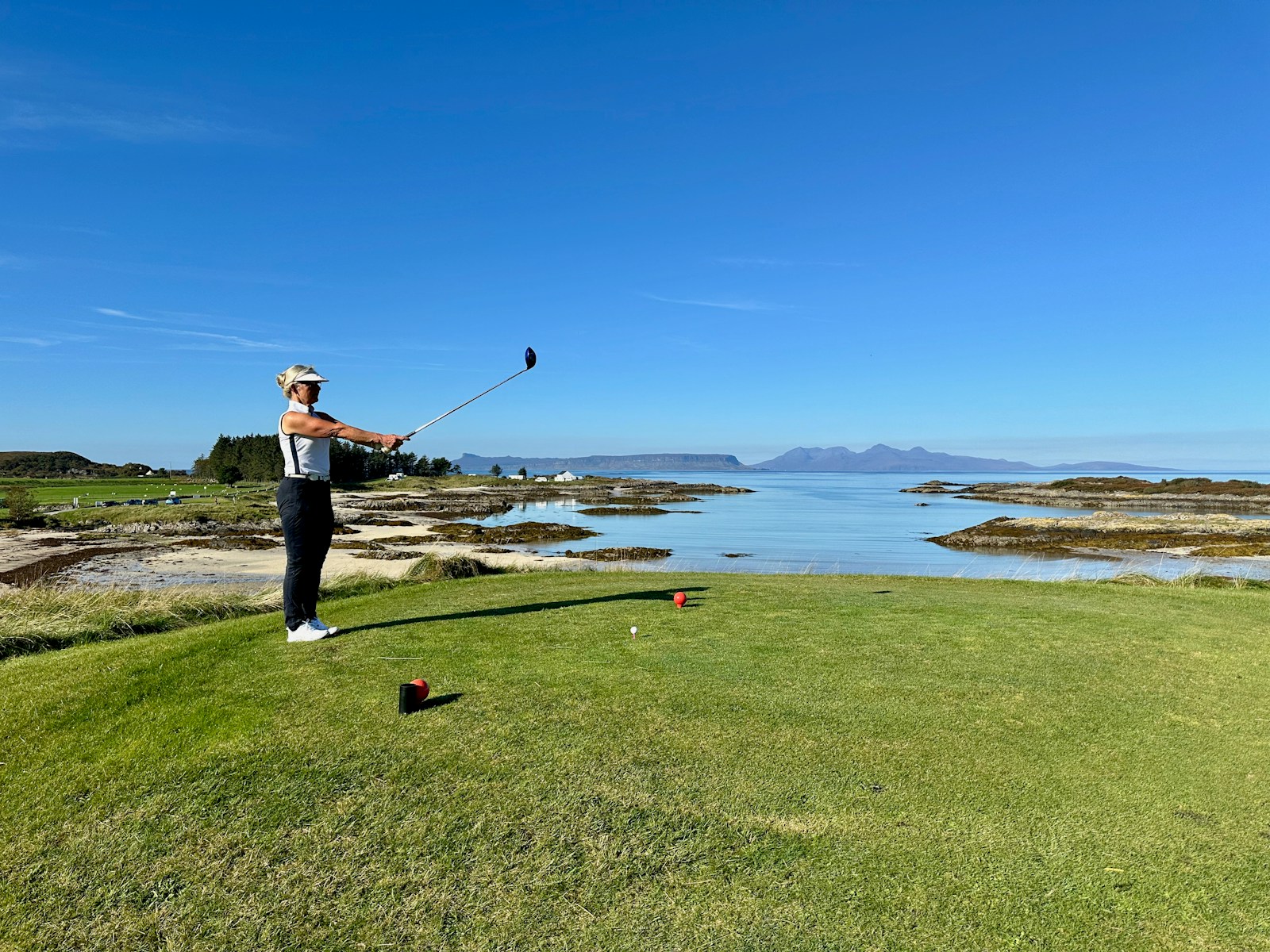 A man is playing golf on a golf course