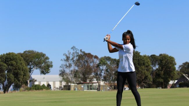 woman holding golf club during daytime