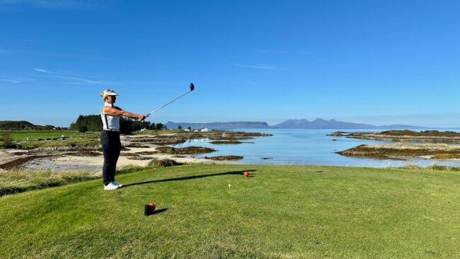 A man is playing golf on a golf course